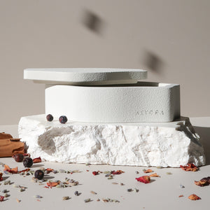 White stone sculpture with 'KIYORA' branding on a neutral background